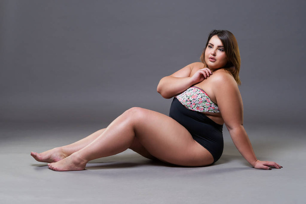 Plus size model in sexy swimsuit, fat woman on gray studio background, overweight female body, full length portrait - Fotografie, Obrázek