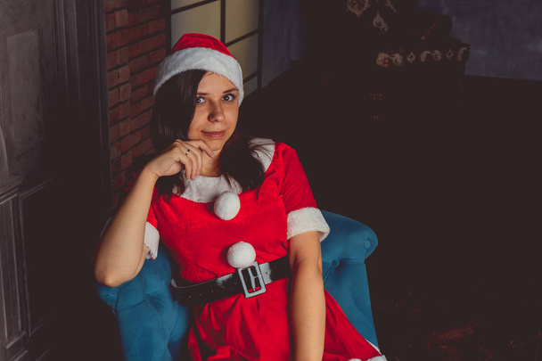 Cute girl dressed as Santa Claus. Happy New Year and merry Christmas - Foto, afbeelding