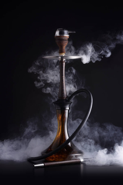 Trendy hookah with cloud of smoke on black background - Фото, зображення