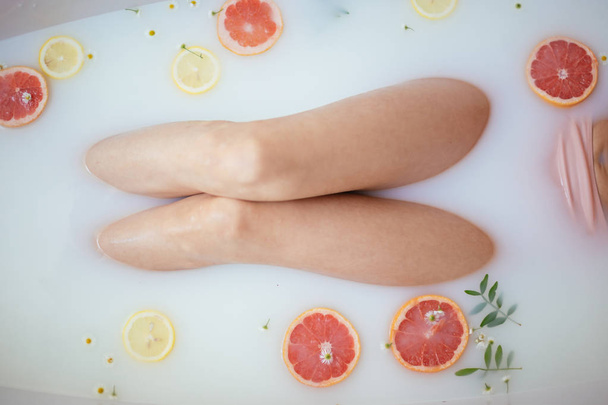 beautiful sexy woman in the milk bath with fruits - 写真・画像