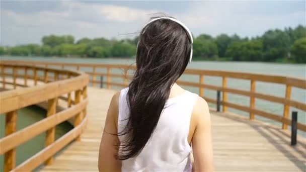 Happy young urban woman enjoy music outdoors - Felvétel, videó