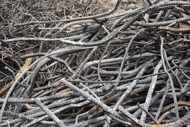 Mangled steel rebar waiting to be recycled at a building demolition site in urban Hanoi Vietnam. The metal will be melted down and made into new products. - Photo, Image