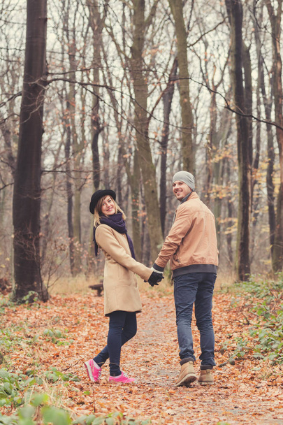 Cute couple in park filled with autumn colors. - 写真・画像