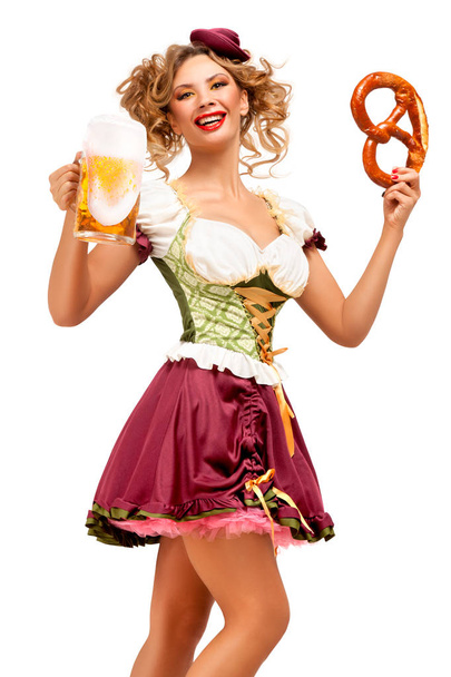 Creative concept photo of Oktoberfest waitress wearing a traditional Bavarian costume with beer and pretzel isolated on white background. - Foto, Imagem