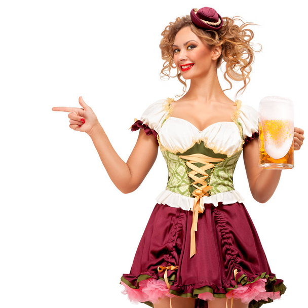 Creative concept photo of Oktoberfest waitress wearing a traditional Bavarian costume with beer isolated on white background. - Fotografie, Obrázek