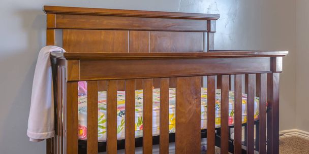 Varnished wooden crib inside a nursery i - Photo, Image