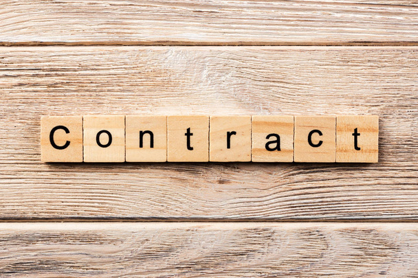 contract word written on wood block. contract text on table, concept. - Photo, Image