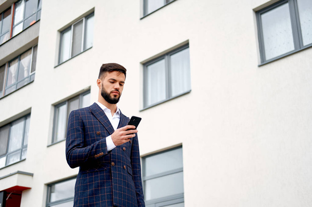 Businessman urban professional business man using mobile phone at office building in city. Professional wearing suit jacket - Foto, Imagem