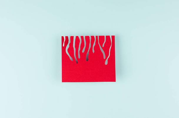 Red square card with flows flow down on modern mint pastel color background. Minimalist abstract backdrop with red square. - 写真・画像