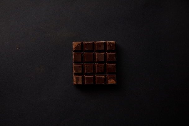 top view of gourmet sweet chocolate on black background - Foto, imagen