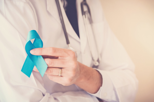 Doctor hand holding Light blue ribbon, Prostate Cancer Awareness - Foto, immagini