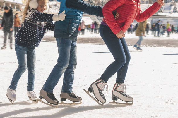 Happy family have outdoor activity, Christmas, outdoor ice skating rink - Photo, image