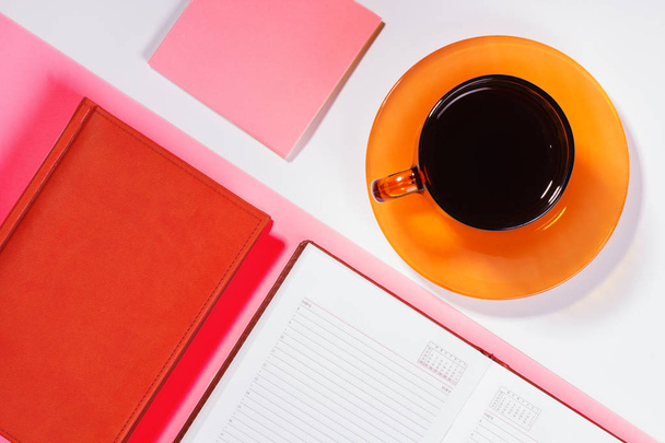Office table with cup of coffee. Colour. Flat lay top view - 写真・画像