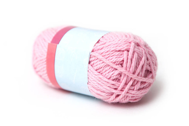 closeup of pink wool bobin on white background - Foto, afbeelding