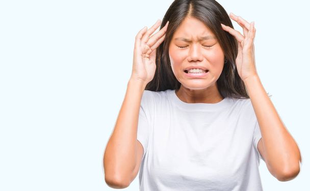 Young asian woman over isolated background with hand on head for pain in head because stress. Suffering migraine. - Фото, зображення