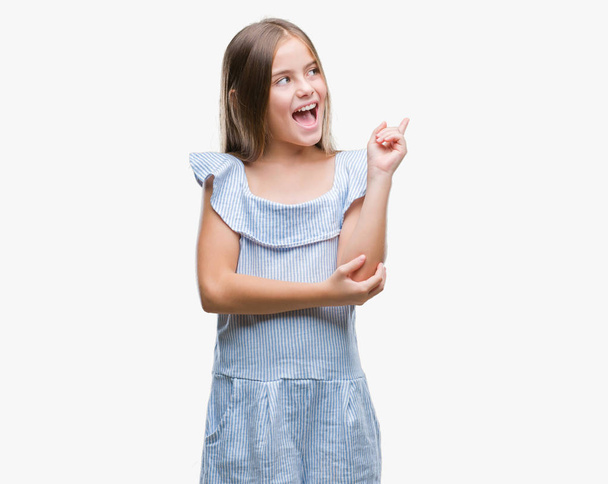 Young beautiful girl over isolated background with a big smile on face, pointing with hand and finger to the side looking at the camera. - Photo, Image