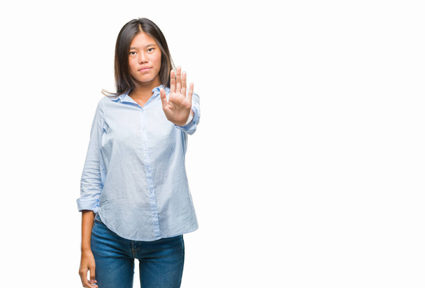 Young asian business woman over isolated background doing stop sing with palm of the hand. Warning expression with negative and serious gesture on the face. - Zdjęcie, obraz
