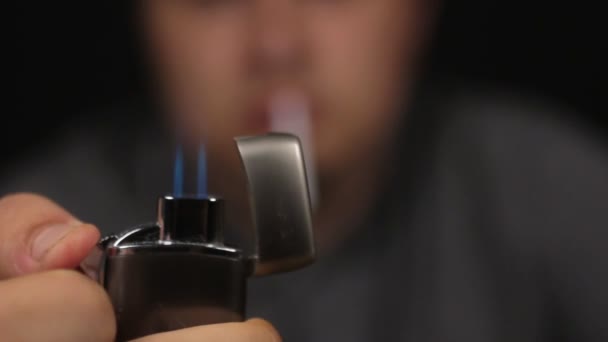Close-up, man sets a gas lighter on fire. Focus on the lighter. - Video