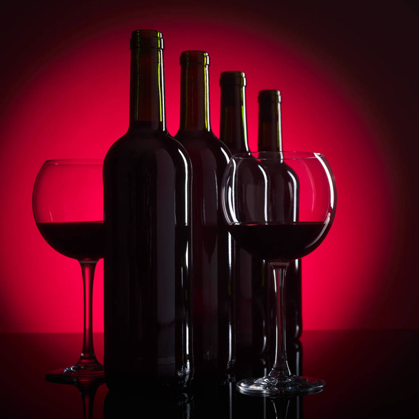 Glasses and bottles of red wine, copy space for your text. - 写真・画像