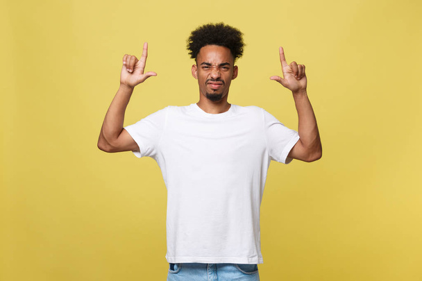 serious dark-skinned African American young man shows a finger upwards - Photo, Image