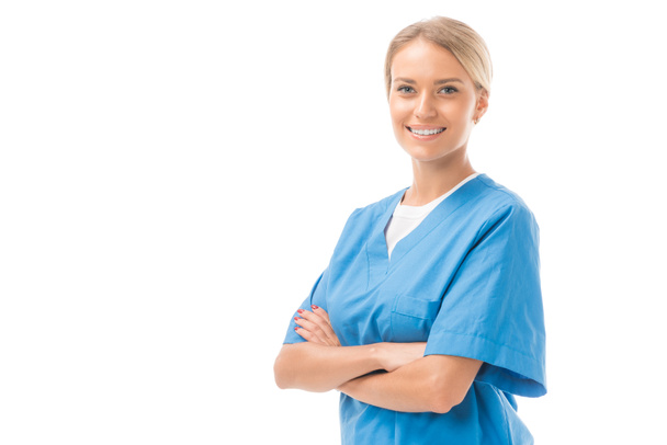 happy young nurse with crossed arms looking at camera isolated on white - Фото, зображення