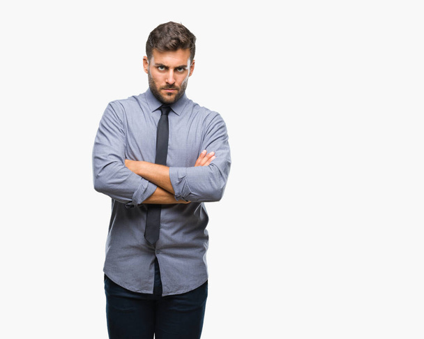 Young handsome business man over isolated background skeptic and nervous, disapproving expression on face with crossed arms. Negative person. - Foto, imagen