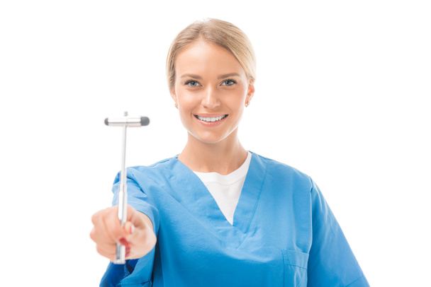 happy young neurologist with reflex hammer isolated on white - Photo, image