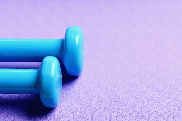 Sports and healthy lifestyle concept. Dumbbells in cyan blue color - Foto, Imagen