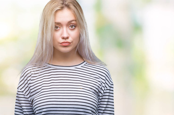 Young blonde woman over isolated background depressed and worry for distress, crying angry and afraid. Sad expression. - Photo, Image