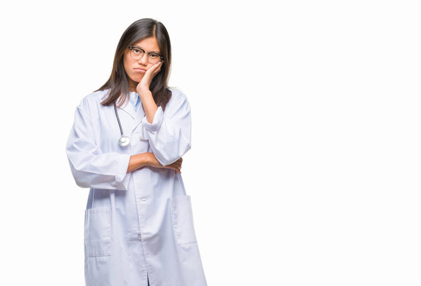 Young asian doctor woman over isolated background thinking looking tired and bored with depression problems with crossed arms. - Photo, image