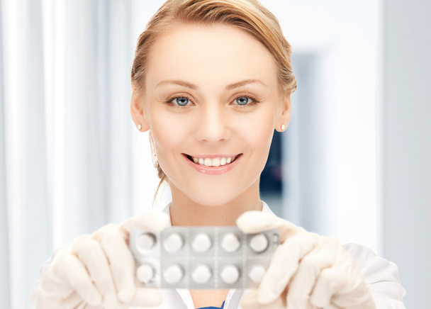 Attractive female doctor with pills - 写真・画像
