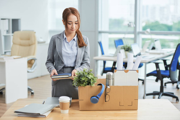 Businesswoman packing her stuff into the box at office - Фото, изображение