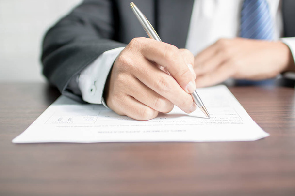 businessman writing on application form. - Фото, изображение