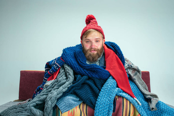 Bearded Man with Flue Sitting on Sofa at Home. Healthcare Concepts. - Foto, Imagen