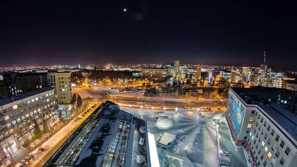 Kharkiv city from above at night winter timelapse. Aerial view of the city center and freedom square. Ukraine. - Photo, image