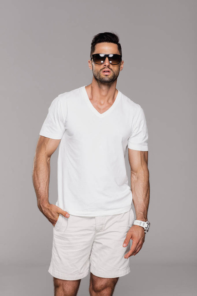 Handsome man in summer clothes wearing sunglasses - 写真・画像