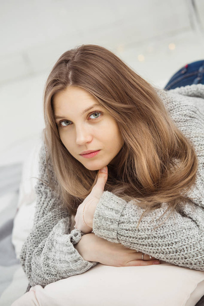 Closeup of beautiful young girl wearing grey sweater - Fotografie, Obrázek