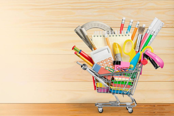 School stationery composition in shopping cart - Фото, зображення