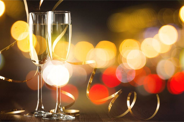Flute glasses of champagne on bright background - 写真・画像