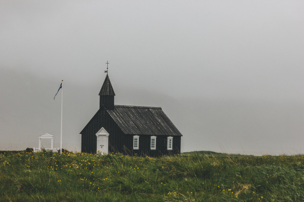 dramatic shot of Budir church on green field at Snaefellsnes, Iceland - Photo, Image