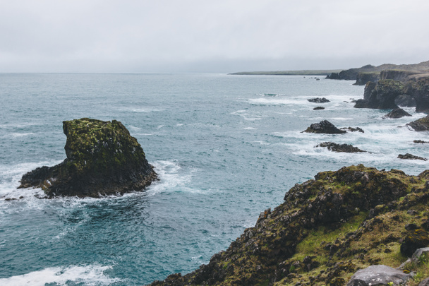 drammatico colpo di rocce nell'oceano blu ad Arnarstapi, Islanda, in un giorno tempestoso
 - Foto, immagini