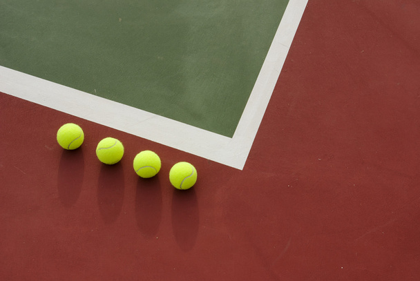 Four tennis balls on the court. - Zdjęcie, obraz