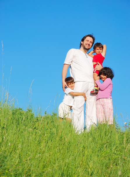 Happy unforgetable childhood on green meadow against blue sky - Foto, Imagen