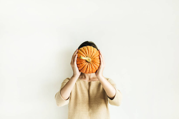 Young woman hold halloween pumpkin. Fall autumn concept. - Фото, изображение