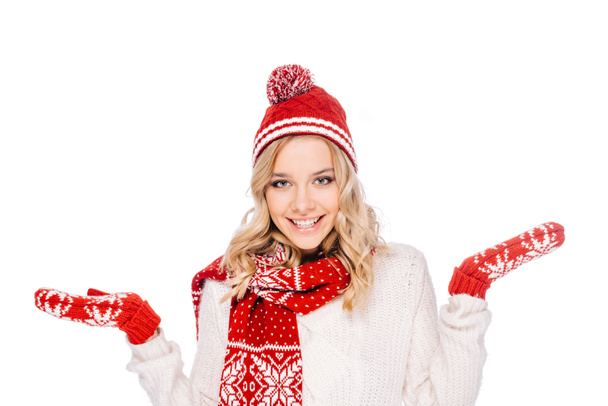 portrait of beautiful young woman in hat, scarf and mittens smiling at camera isolated on white  - Фото, изображение