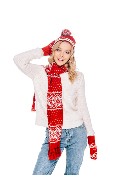 attractive young woman in red hat, scarf and mittens smiling at camera isolated on white - Фото, изображение