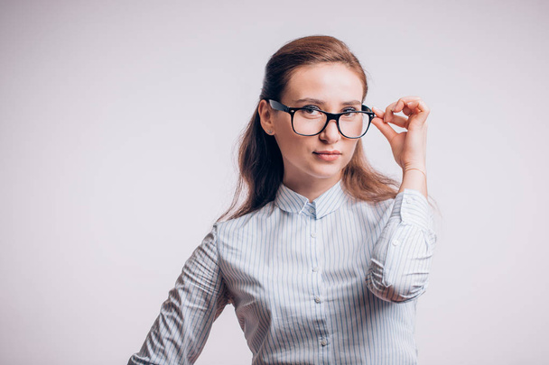 Sure of herself business woman with glasses looking at the camera on a white background with copy space - 写真・画像