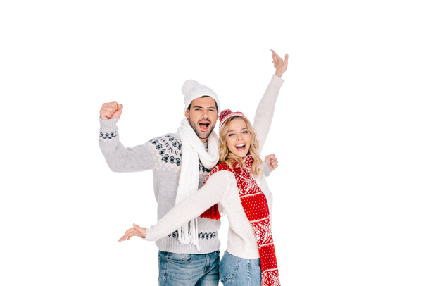 happy young couple in sweaters and hats smiling at camera isolated on white - Photo, Image