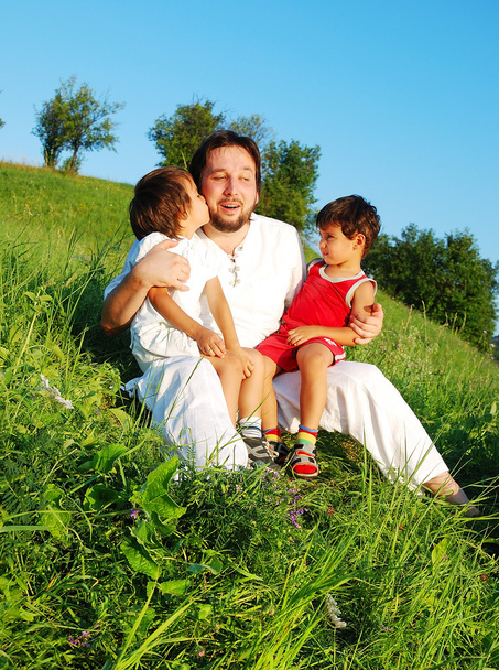 Young father in white with children on beautiful meadow - Fotografie, Obrázek