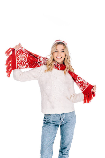 beautiful young woman in sweater, scarf and hat smiling at camera isolated on white - Foto, afbeelding